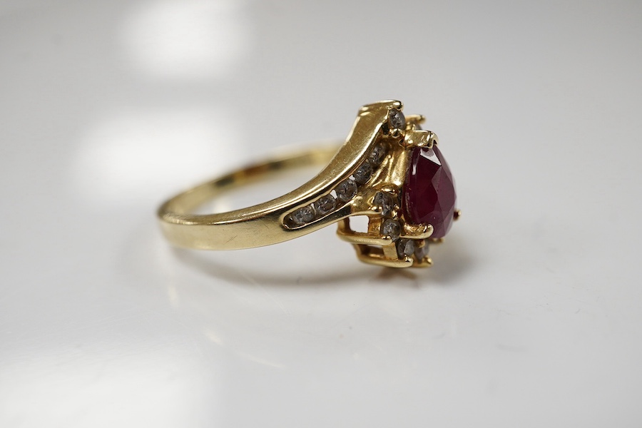 A recent 14k, ruby and diamond cluster set dress ring, size O, gross weight 3.4 grams. Condition - fair to good